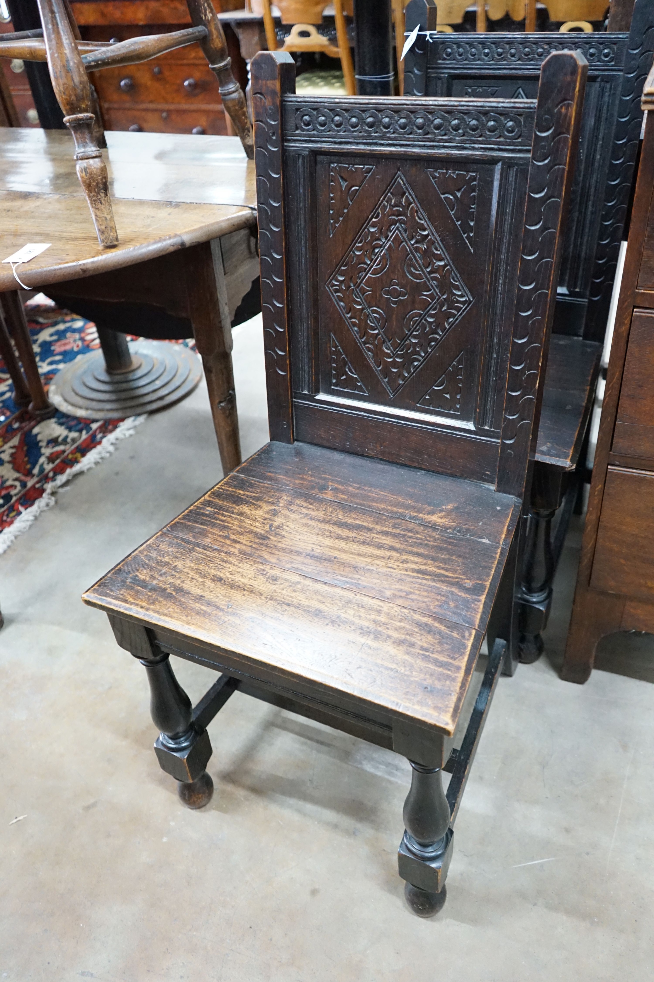 A pair of late Victorian 17th century style carved oak side chairs